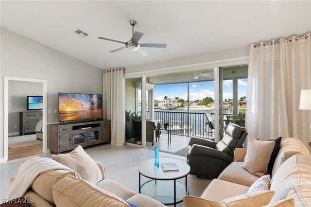 living room with ceiling fan, light hardwood / wood-style floors, and plenty of natural light