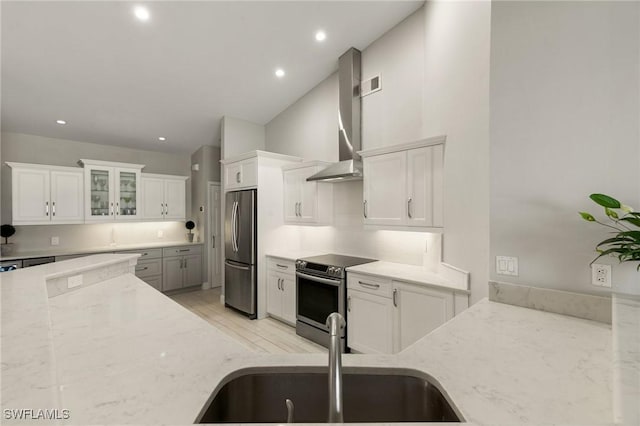 kitchen featuring light stone counters, sink, white cabinets, and appliances with stainless steel finishes