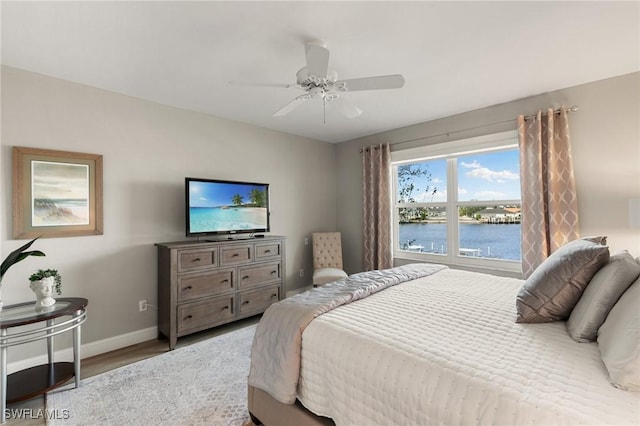 bedroom with light wood-type flooring and ceiling fan