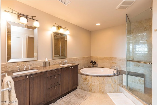 full bath featuring tile patterned flooring, visible vents, a sink, and a bath