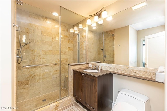 full bathroom featuring toilet, a shower stall, and vanity