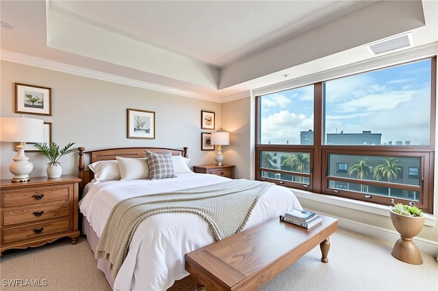bedroom with light colored carpet, a raised ceiling, and ornamental molding