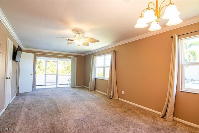 spare room featuring carpet flooring, crown molding, and ceiling fan with notable chandelier