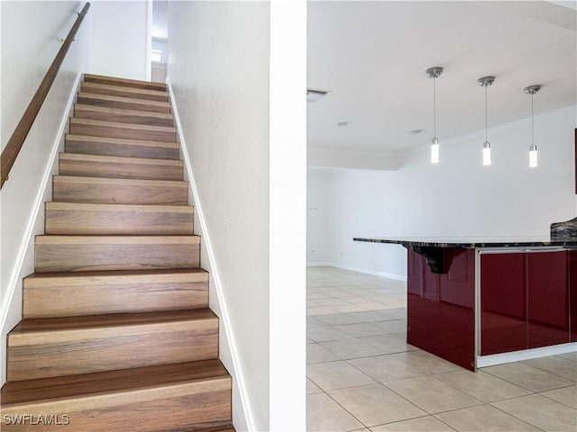 staircase featuring tile patterned floors