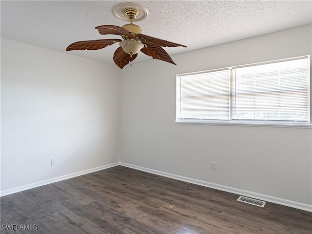 unfurnished room with dark hardwood / wood-style floors, ceiling fan, and a wealth of natural light