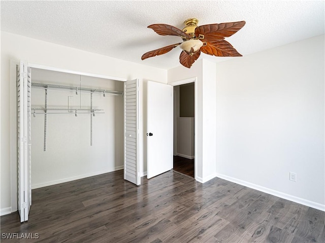 unfurnished bedroom featuring a textured ceiling, ceiling fan, dark wood-type flooring, and a closet