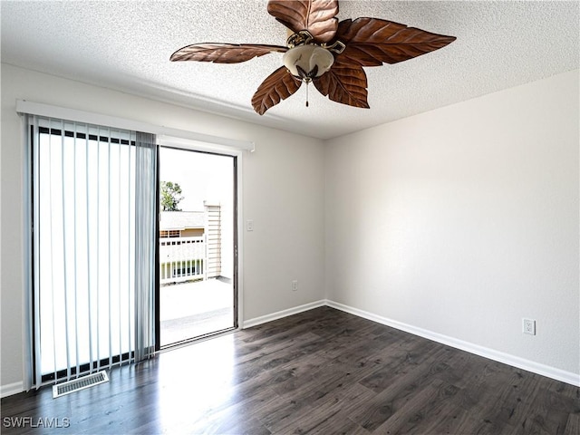 unfurnished room with ceiling fan, dark hardwood / wood-style flooring, and a textured ceiling