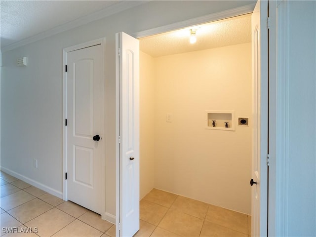 laundry area featuring washer hookup, hookup for an electric dryer, crown molding, a textured ceiling, and light tile patterned floors