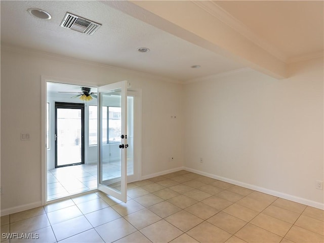 empty room with beamed ceiling, ceiling fan, ornamental molding, and light tile patterned floors