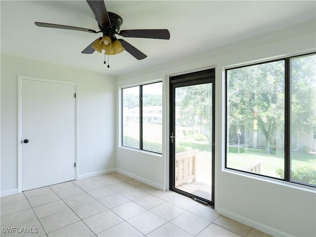 tiled empty room featuring ceiling fan