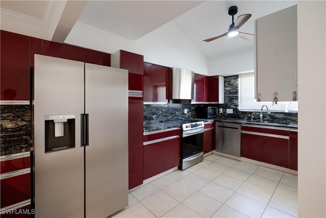 kitchen with lofted ceiling, wall chimney range hood, ceiling fan, tasteful backsplash, and stainless steel appliances