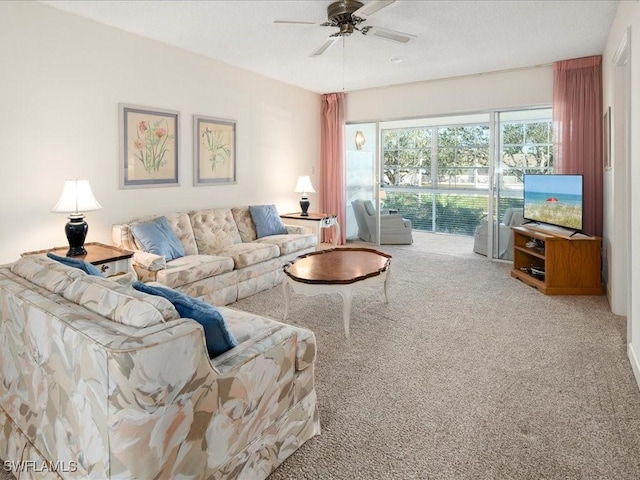 carpeted living room with ceiling fan