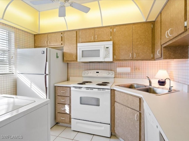 kitchen with ceiling fan, sink, white appliances, washer / dryer, and light tile patterned floors