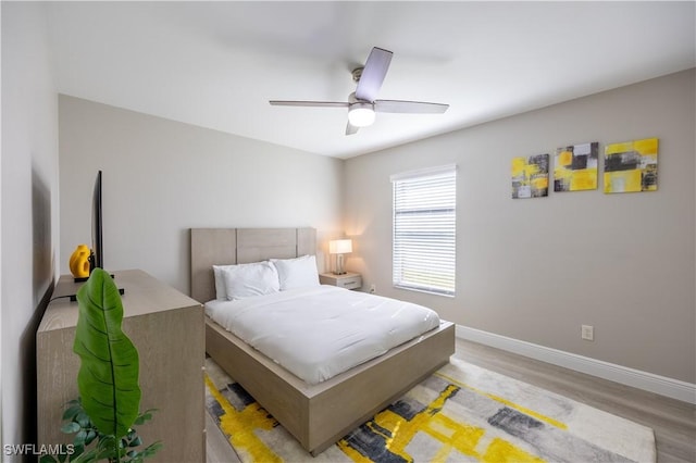 bedroom with ceiling fan and light hardwood / wood-style floors