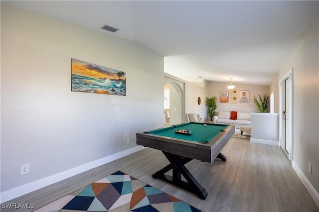 game room with hardwood / wood-style floors, vaulted ceiling, and pool table