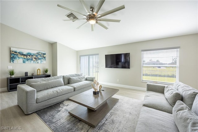 living room with ceiling fan, light hardwood / wood-style floors, and lofted ceiling