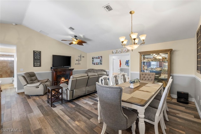 4560 Key Largo Ln, Bonita Springs, FL 34134 - dining space featuring a chandelier, lofted ceiling, a ceiling fan, dark wood-style floors, and a warm lit fireplace