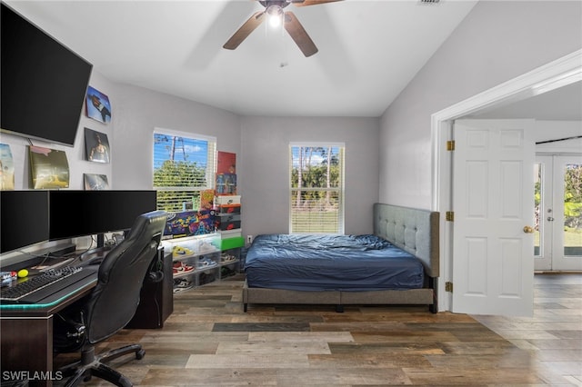 4560 Key Largo Ln, Bonita Springs, FL 34134 - bedroom with wood finished floors, multiple windows, vaulted ceiling, and a desk