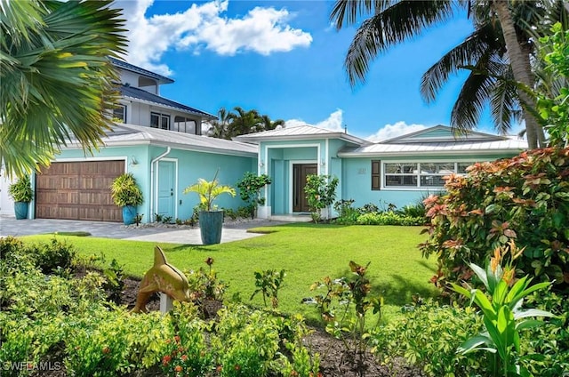 view of front of house featuring a garage and a front yard