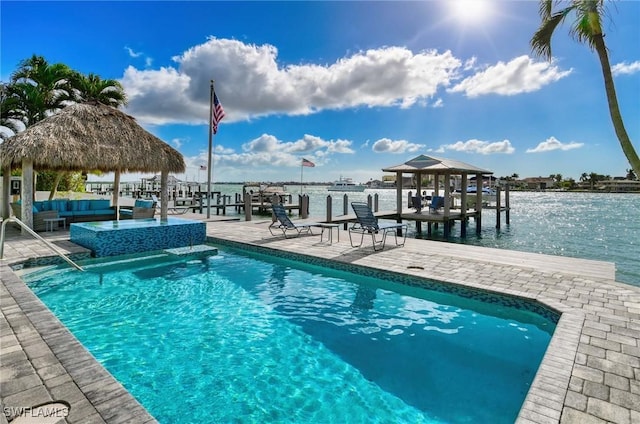 view of pool with a gazebo, a patio area, a water view, and an outdoor hangout area