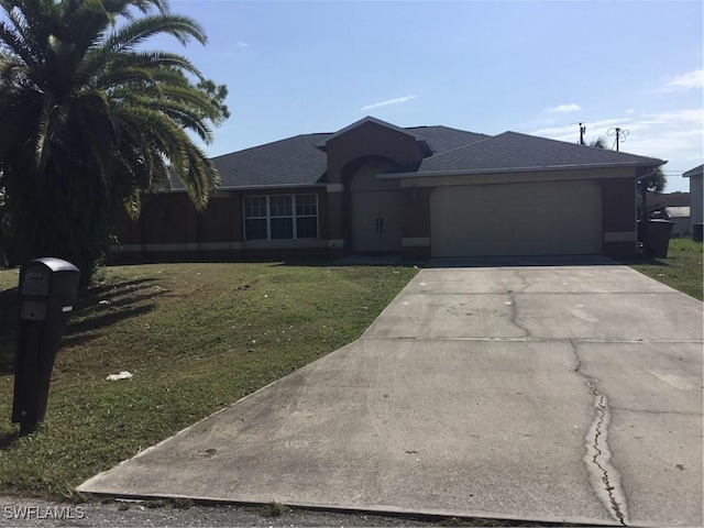 single story home featuring a garage and a front yard