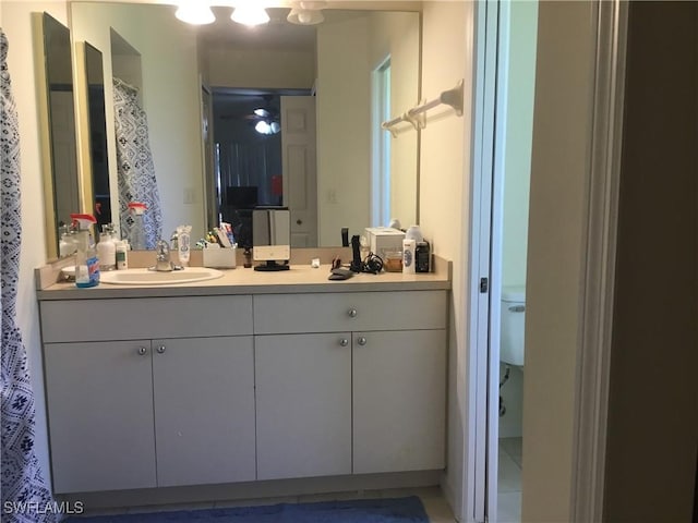 bathroom featuring ceiling fan and vanity