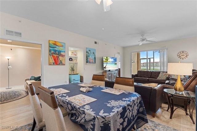 dining space featuring ceiling fan and light hardwood / wood-style flooring