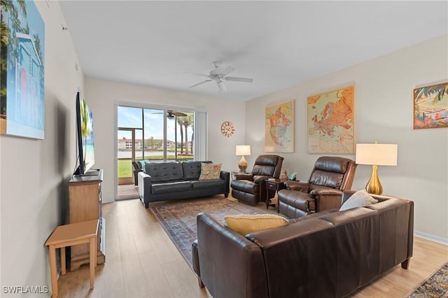 living room featuring ceiling fan and light hardwood / wood-style flooring