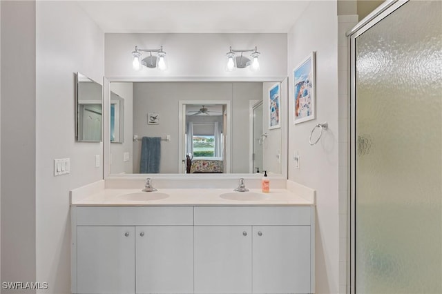 bathroom with vanity and a shower with shower door