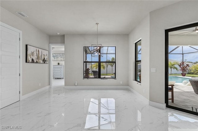 unfurnished dining area featuring an inviting chandelier