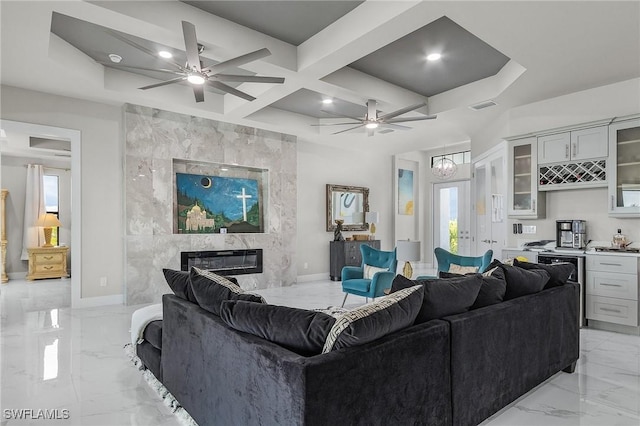 living room with a fireplace, beam ceiling, and coffered ceiling