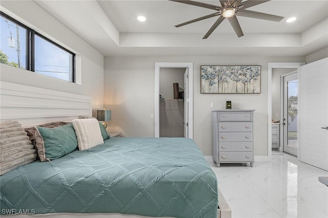 bedroom with ceiling fan, a spacious closet, multiple windows, and a closet