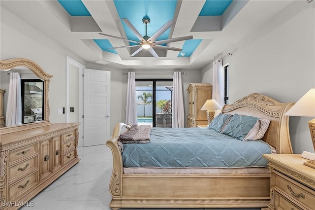 bedroom featuring access to outside, a raised ceiling, and ceiling fan