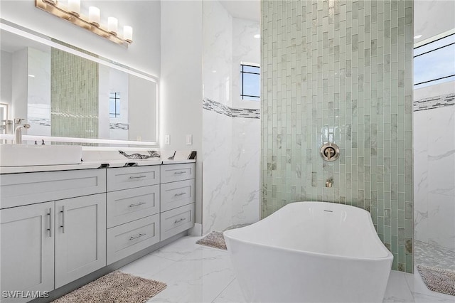 bathroom with vanity, separate shower and tub, and a wealth of natural light