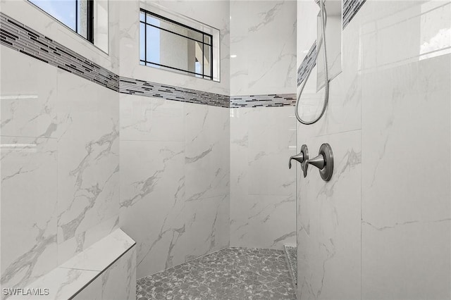 bathroom featuring tiled shower