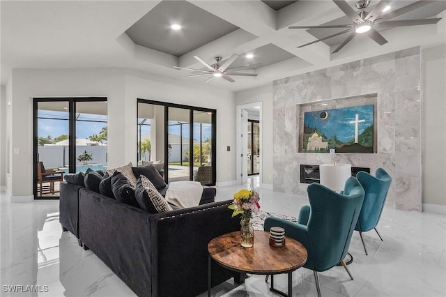 living room featuring ceiling fan and coffered ceiling