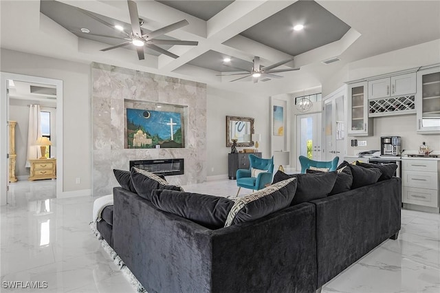 living room featuring a fireplace, beamed ceiling, and coffered ceiling