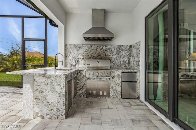 view of patio featuring an outdoor kitchen, grilling area, and sink