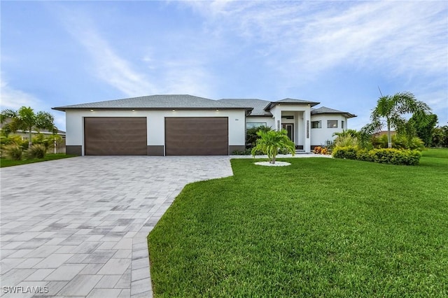 view of front of home with a front lawn and a garage