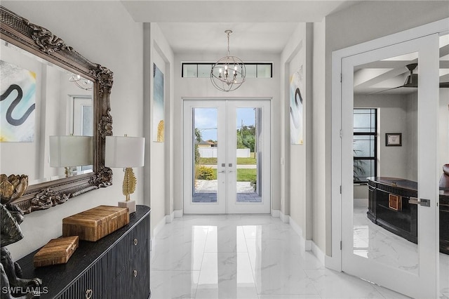 entryway with french doors and a notable chandelier