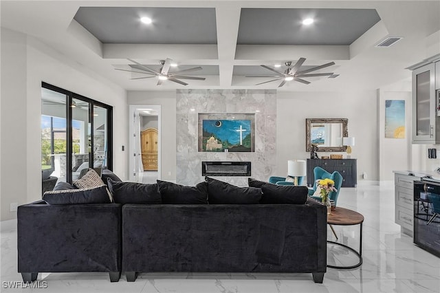 living room featuring a premium fireplace, beamed ceiling, beverage cooler, and coffered ceiling