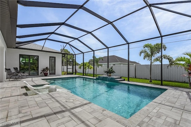 view of pool with a patio, pool water feature, and glass enclosure