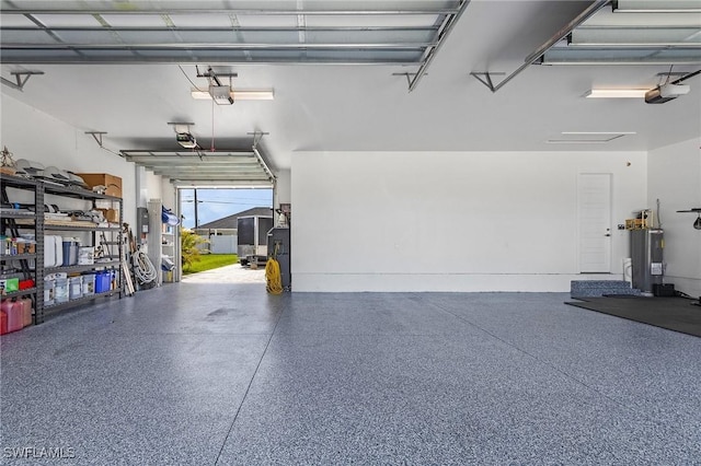 garage with electric water heater and a garage door opener