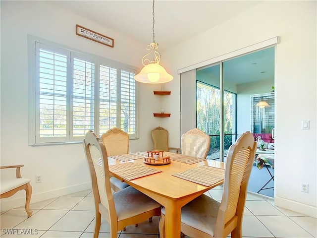 tiled dining space featuring a healthy amount of sunlight