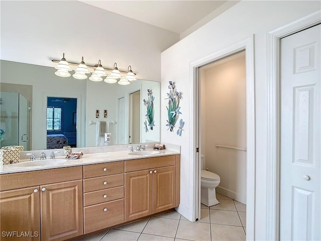 bathroom featuring walk in shower, tile patterned floors, toilet, and vanity