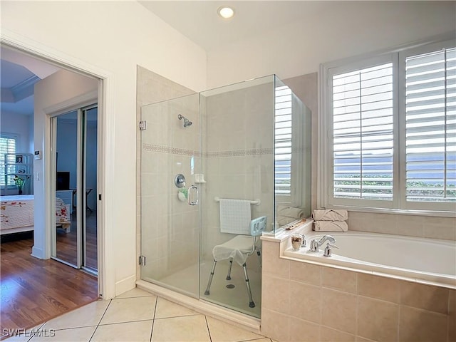 bathroom with tile patterned floors and separate shower and tub