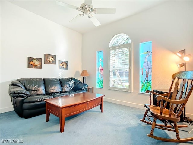 carpeted living room with ceiling fan