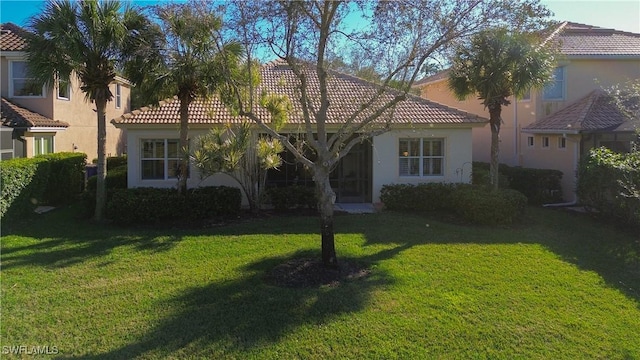 mediterranean / spanish house with a front yard