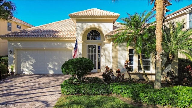 mediterranean / spanish home featuring a garage