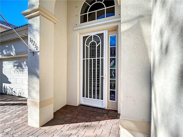 view of exterior entry with a garage